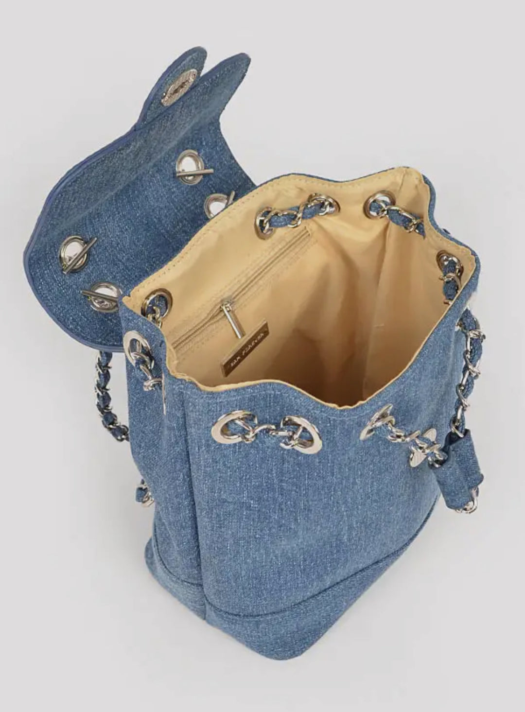 Denim bucket bag with chain details on a light gray background