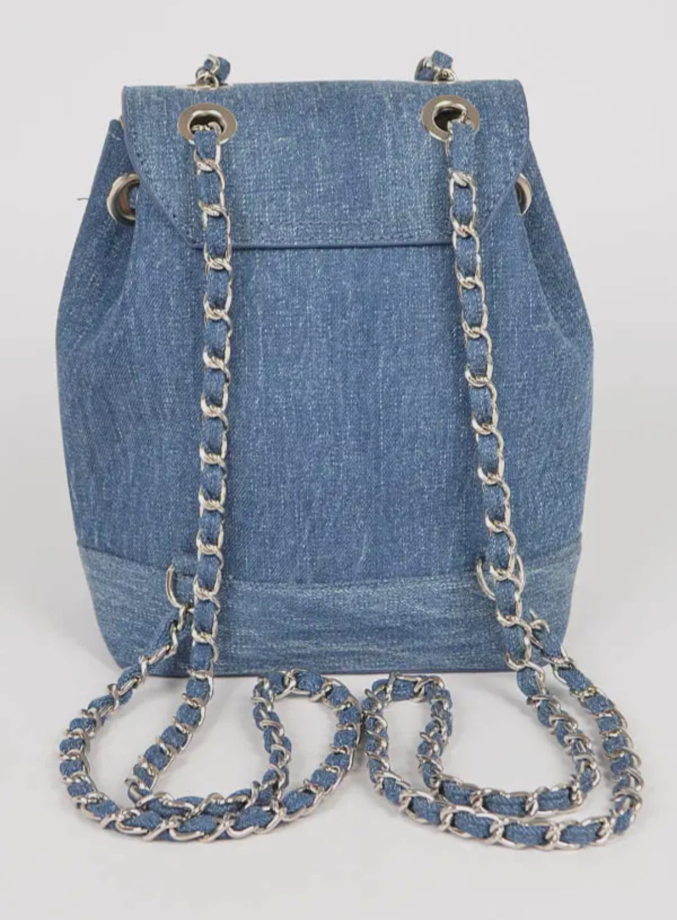 Denim bucket bag with chain detail on a white background