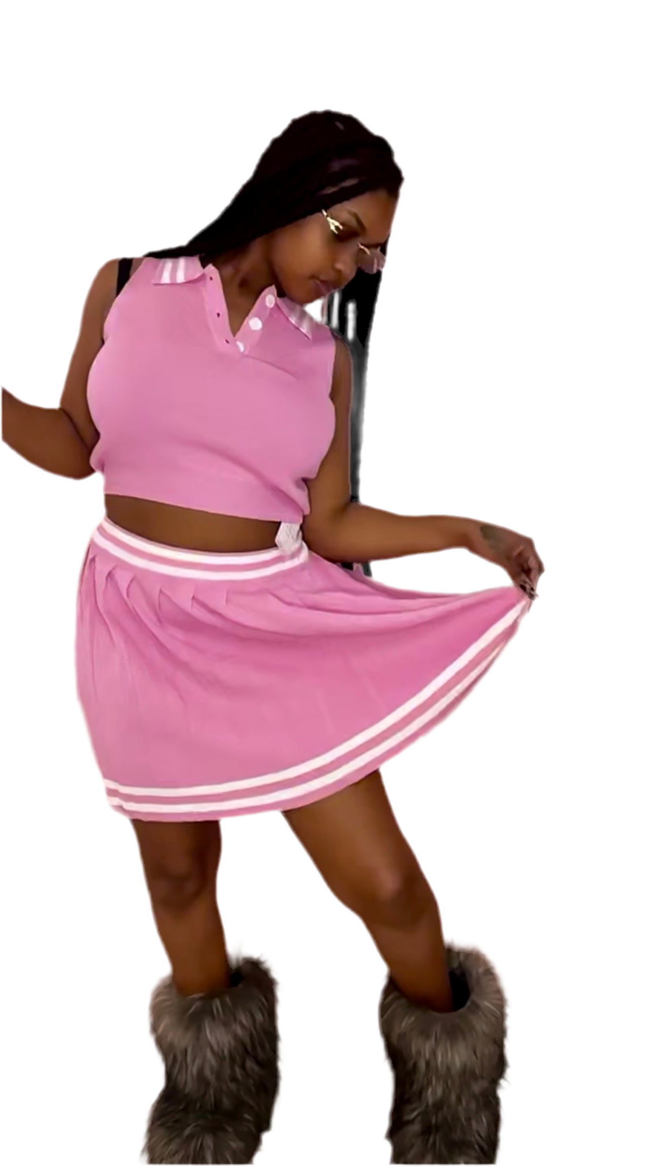 A woman wearing a pink crop top and a matching ruffle skirt, with a handbag and high heels.